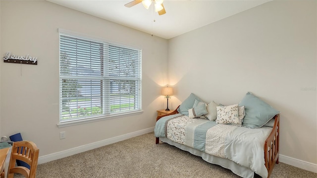 carpeted bedroom with a ceiling fan and baseboards