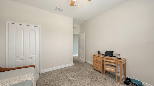 interior space with light carpet, baseboards, visible vents, and a ceiling fan