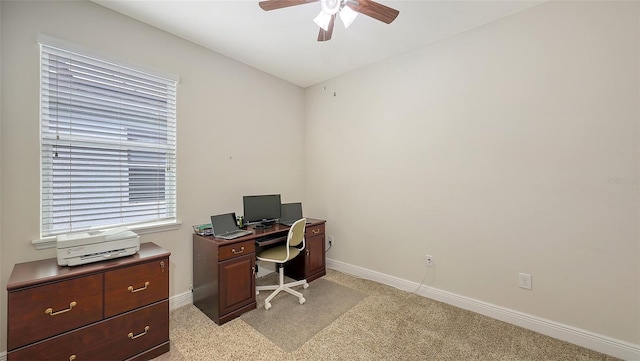 office featuring ceiling fan, baseboards, and light colored carpet