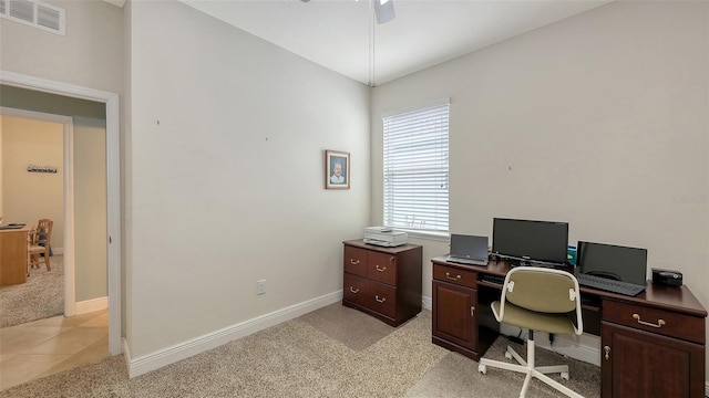 home office featuring light carpet, visible vents, a ceiling fan, and baseboards