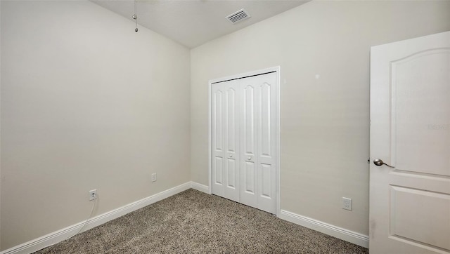 unfurnished bedroom featuring a closet, baseboards, visible vents, and carpet flooring