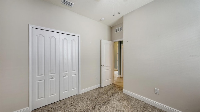 unfurnished bedroom featuring a closet, carpet, visible vents, and baseboards