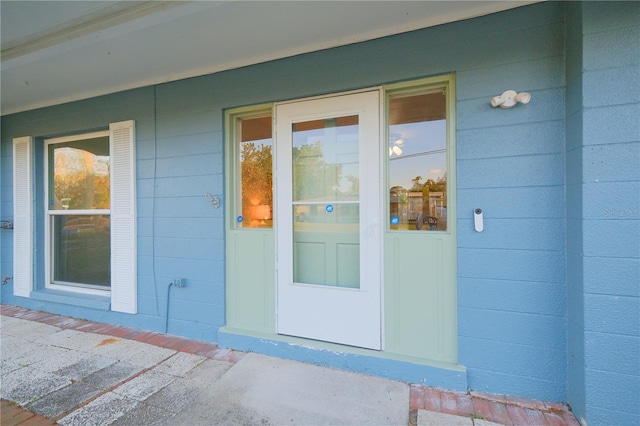 doorway to property with concrete block siding