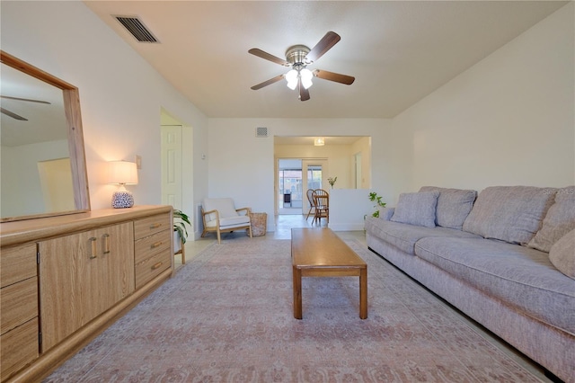 living room featuring visible vents and ceiling fan