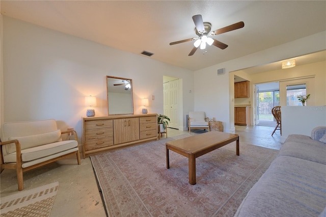 living room featuring concrete floors, visible vents, and a ceiling fan