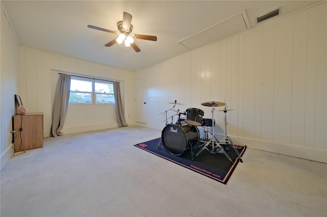 interior space with a ceiling fan, visible vents, and attic access