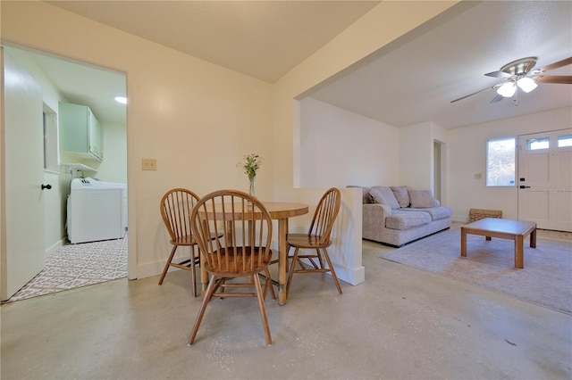 dining space with washer / dryer, concrete floors, baseboards, and a ceiling fan