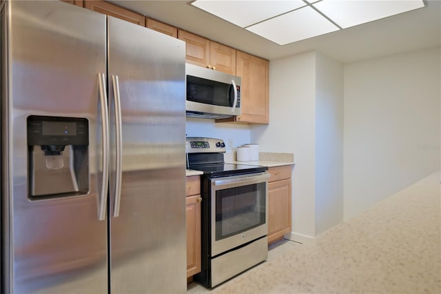 kitchen featuring light brown cabinets and appliances with stainless steel finishes