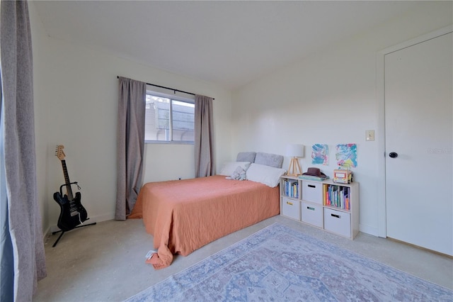 bedroom featuring concrete flooring