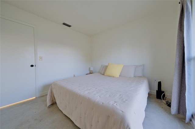 bedroom featuring concrete floors and visible vents