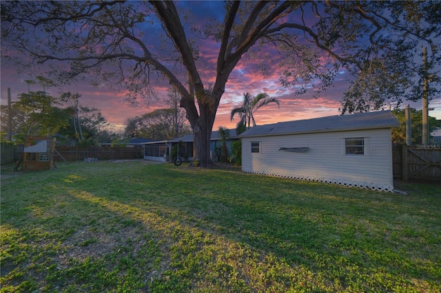 view of yard featuring a fenced backyard and a sunroom