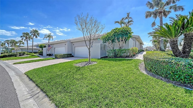 view of side of home with an attached garage, a lawn, decorative driveway, and stucco siding