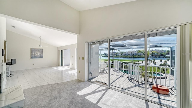 doorway to outside with visible vents, a water view, tile patterned flooring, carpet floors, and high vaulted ceiling