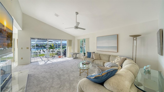 living area with carpet floors, visible vents, ceiling fan, and high vaulted ceiling