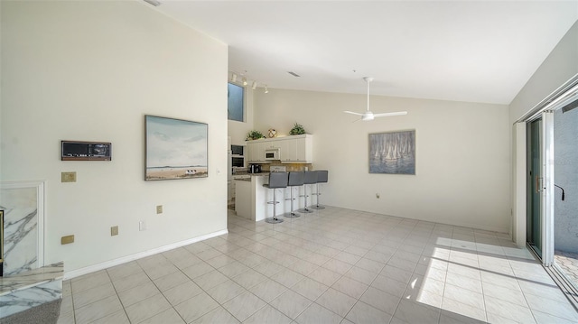 living area featuring vaulted ceiling and ceiling fan