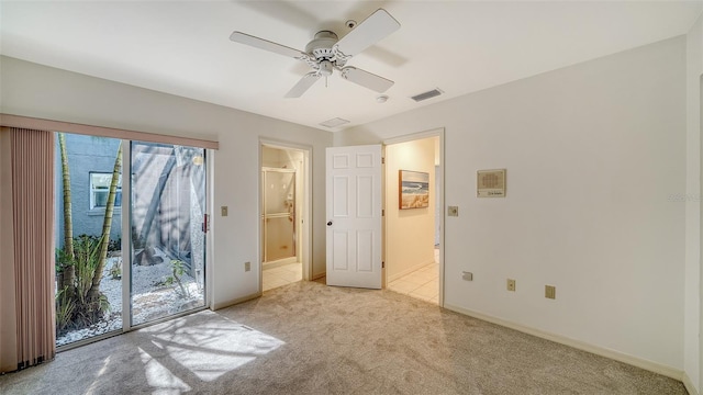 tiled empty room featuring carpet floors, visible vents, baseboards, and a ceiling fan