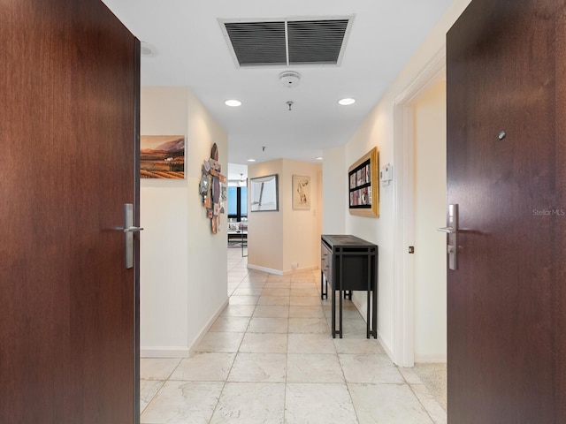 hall featuring recessed lighting, visible vents, and baseboards