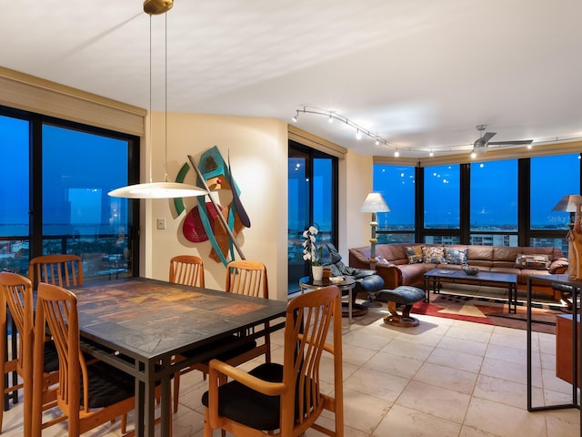 dining room with rail lighting and ceiling fan