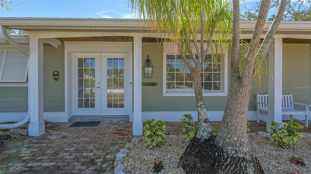 property entrance featuring french doors and covered porch