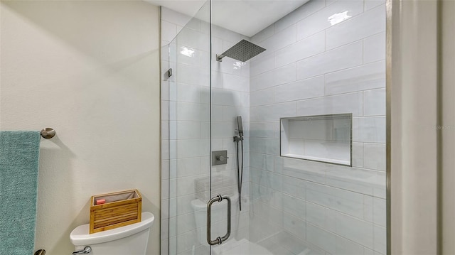 bathroom featuring a shower stall and toilet