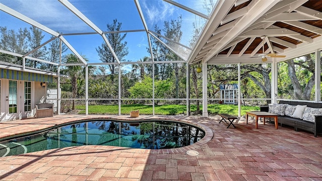 outdoor pool with a ceiling fan, a lanai, french doors, a patio area, and outdoor lounge area