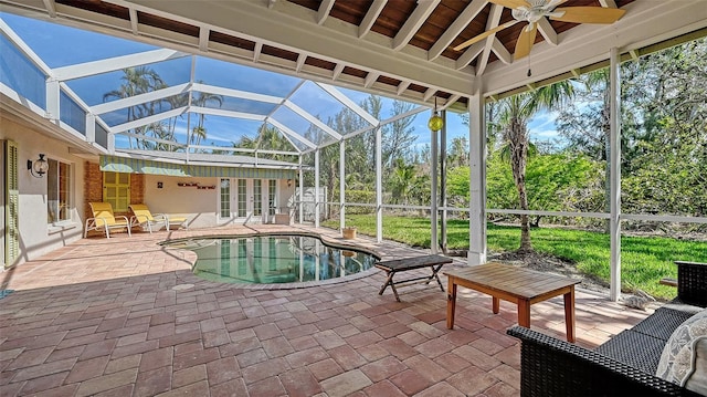 outdoor pool featuring a patio area, glass enclosure, a ceiling fan, and french doors