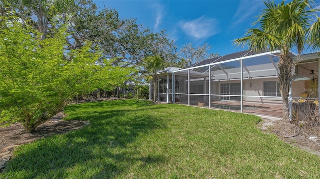 view of yard featuring a lanai, a patio area, and an outdoor pool