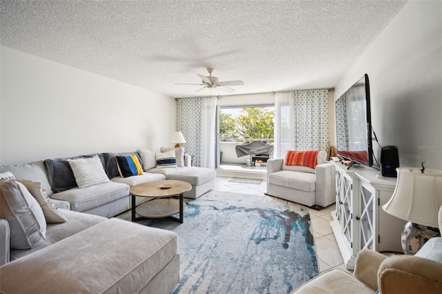 living room with light tile patterned floors, a textured ceiling, and a ceiling fan