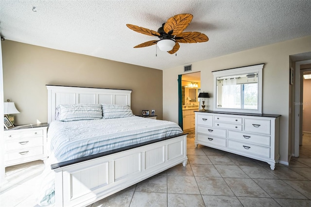 bedroom with visible vents, a textured ceiling, and light tile patterned flooring