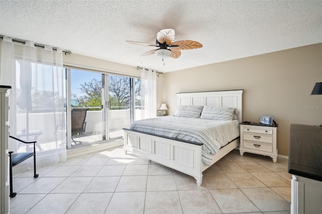 bedroom featuring a ceiling fan, access to outside, a textured ceiling, and light tile patterned floors