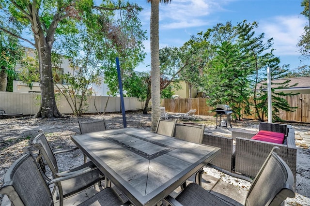 view of patio / terrace featuring a fenced backyard, a grill, and outdoor dining area