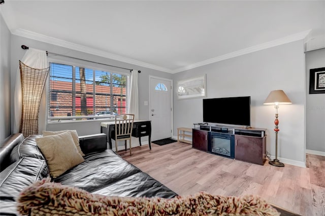living area with baseboards, ornamental molding, and wood finished floors