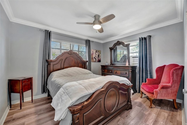 bedroom featuring ornamental molding, baseboards, and light wood finished floors