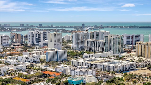 birds eye view of property featuring a water view and a city view