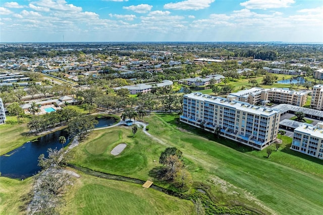 drone / aerial view with a water view and golf course view