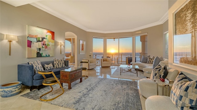 living room with arched walkways and ornamental molding