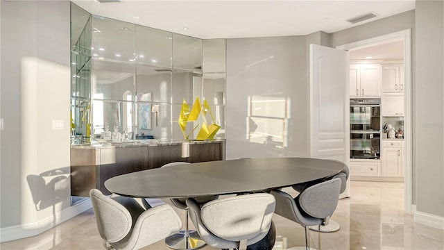 dining area with visible vents, marble finish floor, and baseboards