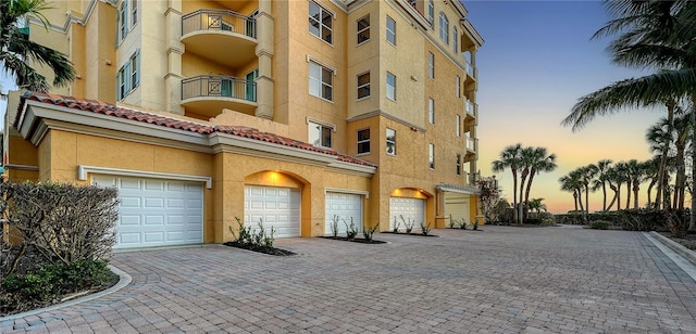 view of property with driveway and a garage