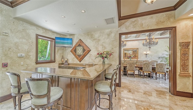 bar featuring visible vents, ornamental molding, recessed lighting, bar area, and a textured wall