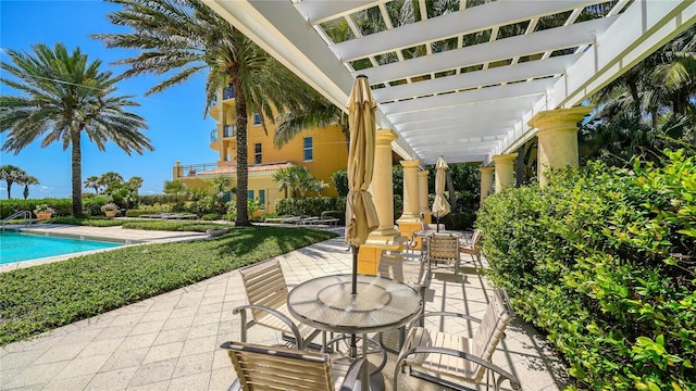 view of patio / terrace featuring a community pool and a pergola