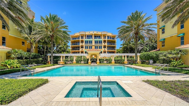 community pool with a patio, a community hot tub, and a pergola