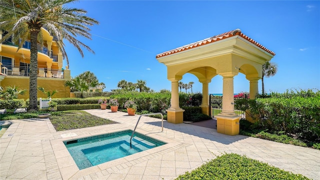 view of swimming pool with a patio area and a hot tub