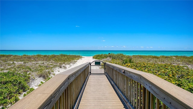 view of home's community featuring a beach view and a water view