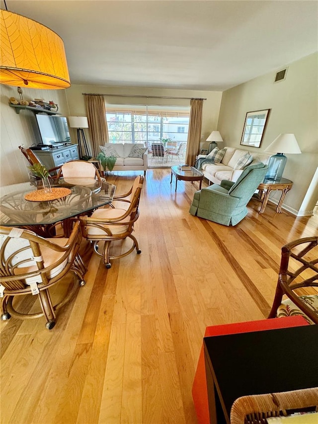 living room with visible vents and hardwood / wood-style flooring