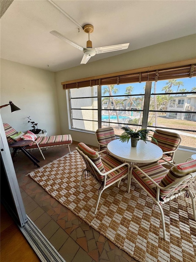 sunroom / solarium with a ceiling fan