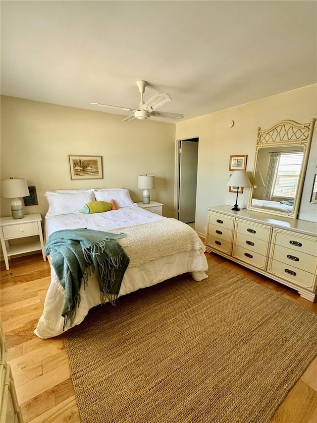 bedroom with a closet, light wood-style flooring, and ceiling fan