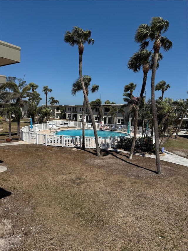 community pool featuring a patio area and fence