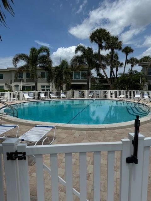 pool featuring a patio and fence