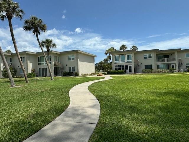 view of property's community with a lawn