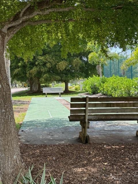 view of property's community featuring shuffleboard